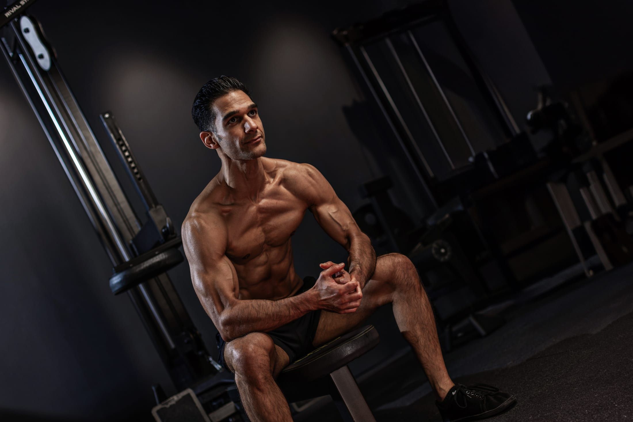 Gurinder Sandhu seated on a bench between sets in the gym at UNTIL Soho