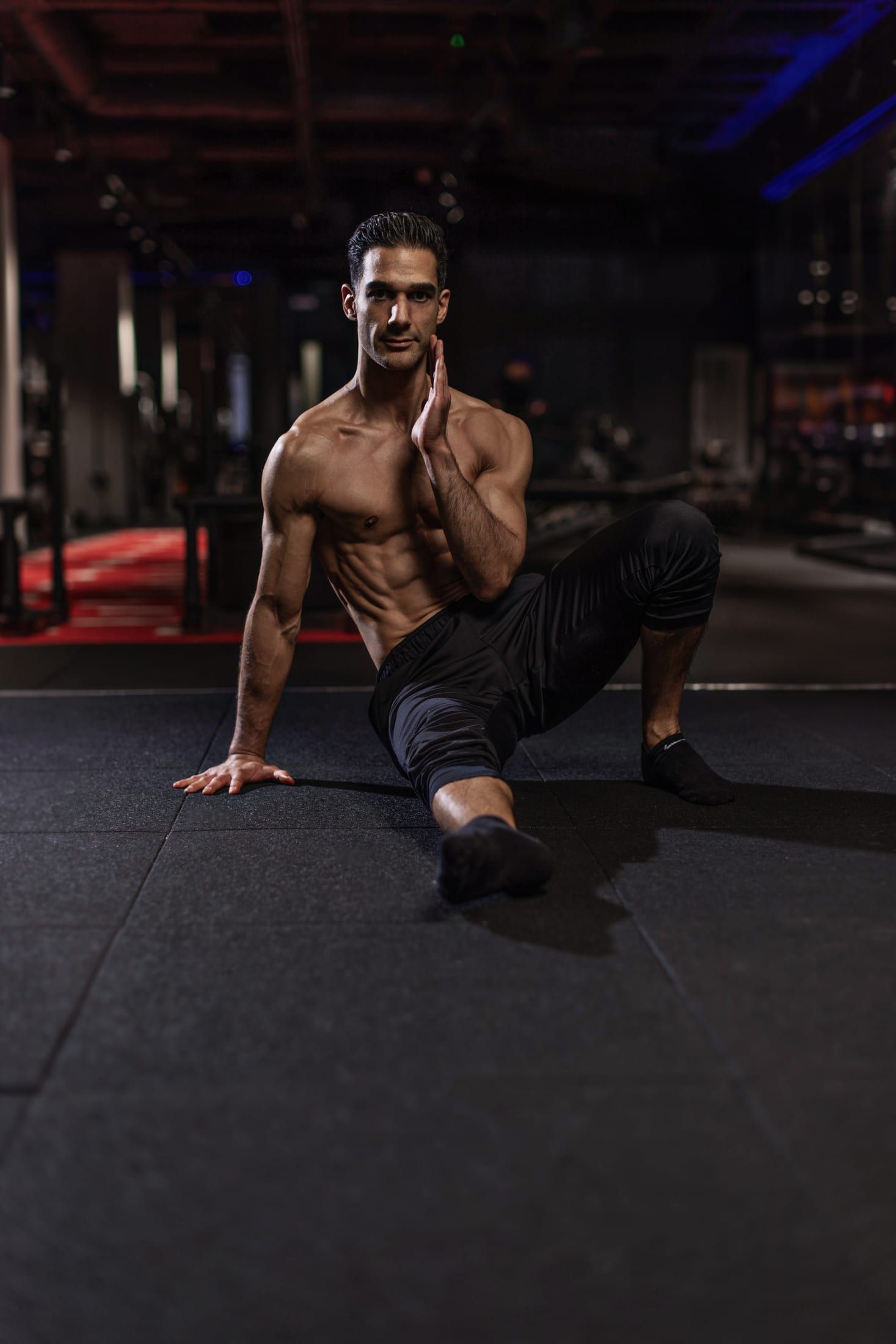 Gurinder Sandhu, back pain specialist and personal trainer, in a seated mobility stretch at the gym in Soho, London