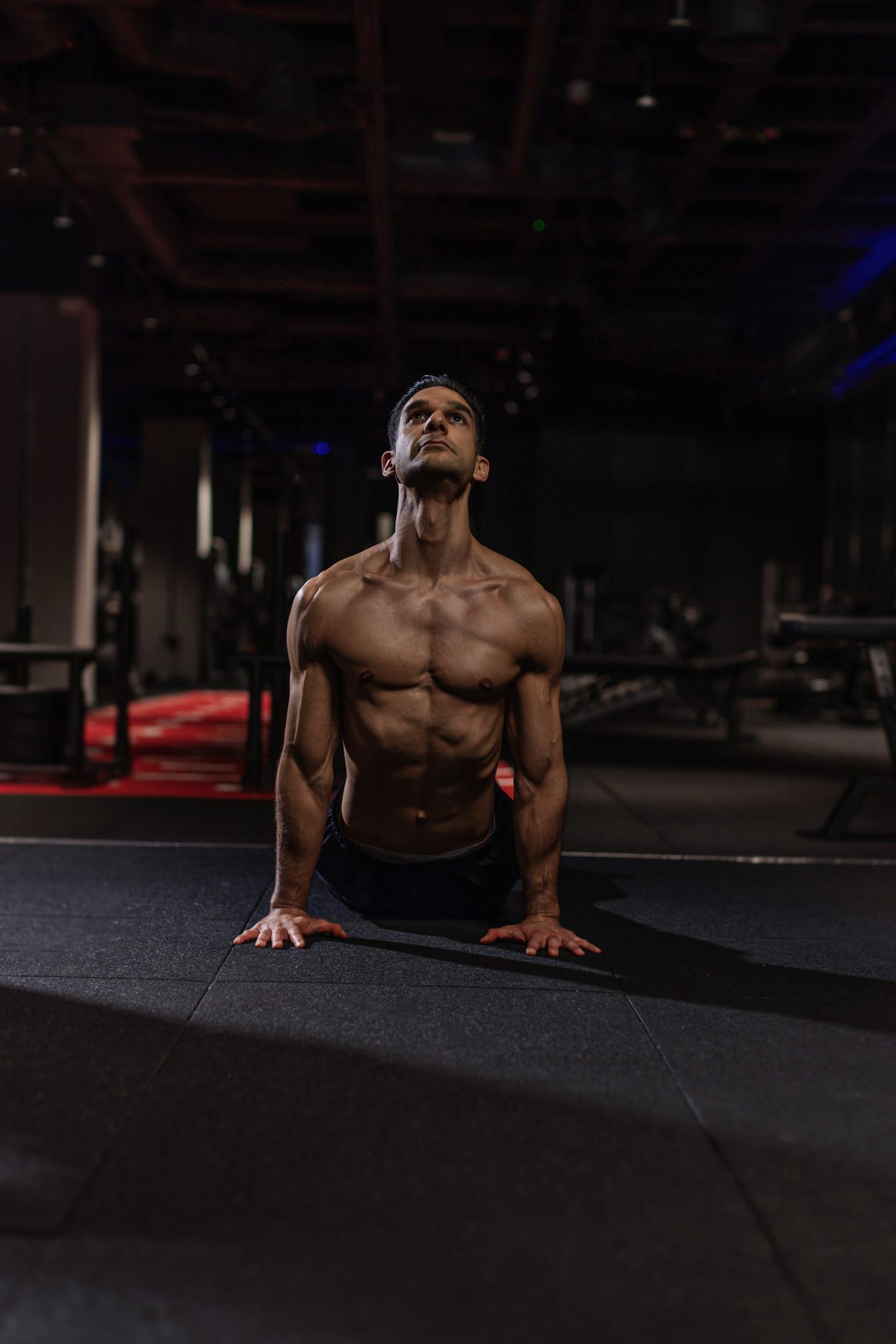 Gurinder Sandhu moving through a spinal extension on the gym floor at UNTIL Soho, London